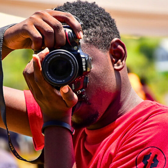 A KNOB digital photographer on duty at a shoot in Kwale County, Kenya